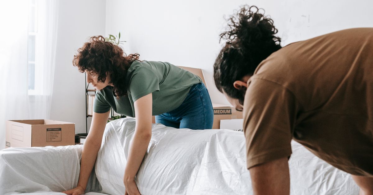 Decorative Pexels stock photo of people wrapping a sofa for a move